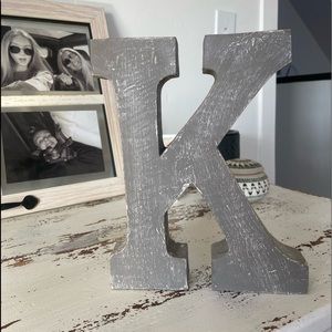 grey wooden letter “k”